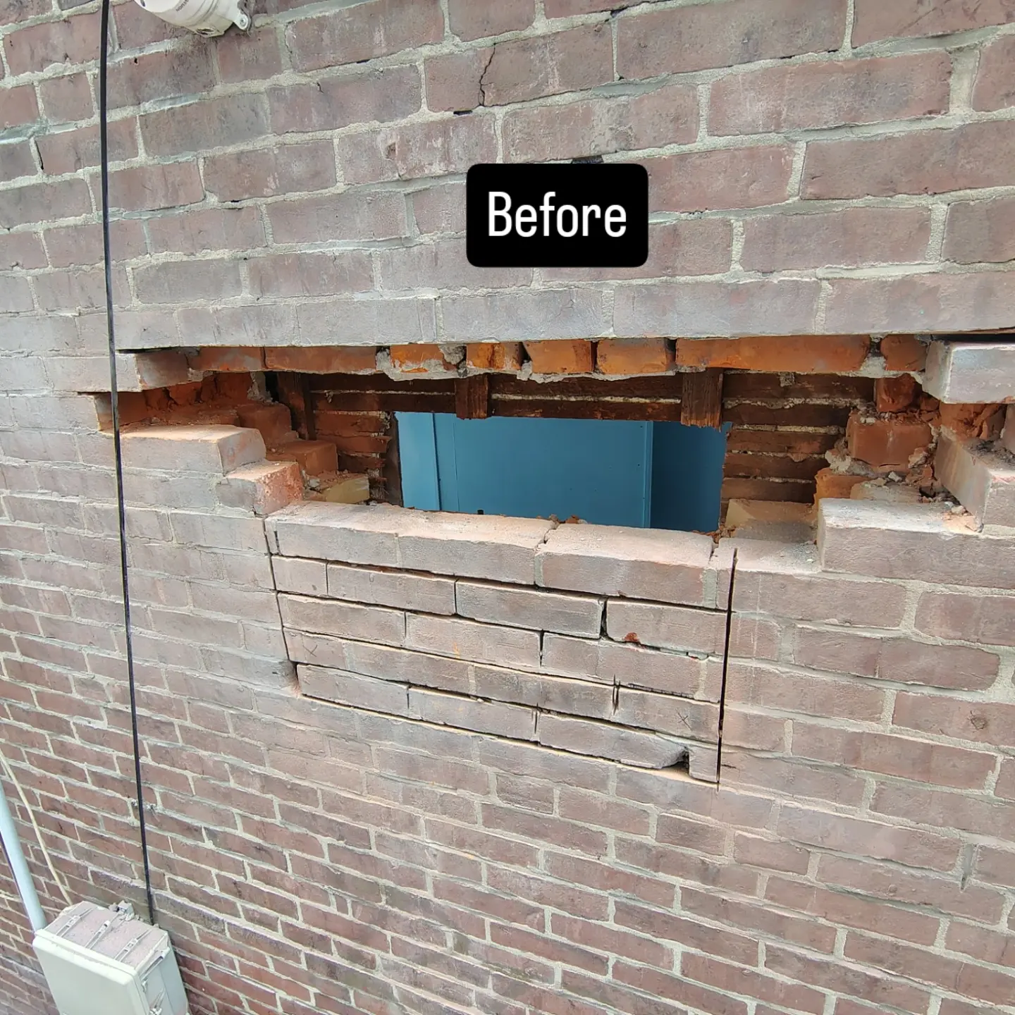 Opening cut into a brick wall before repair