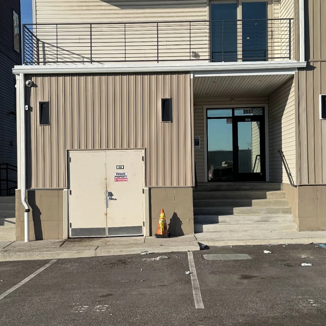 Finished commercial building entrance with new siding and trim