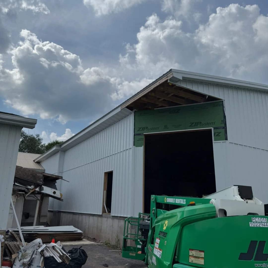 Metal-clad building with a framed opening under construction