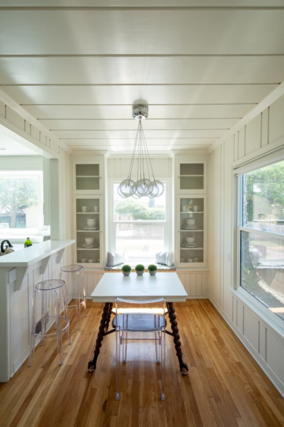 Bright finished interior with built-in cabinetry, shiplap ceiling and hardwood floors